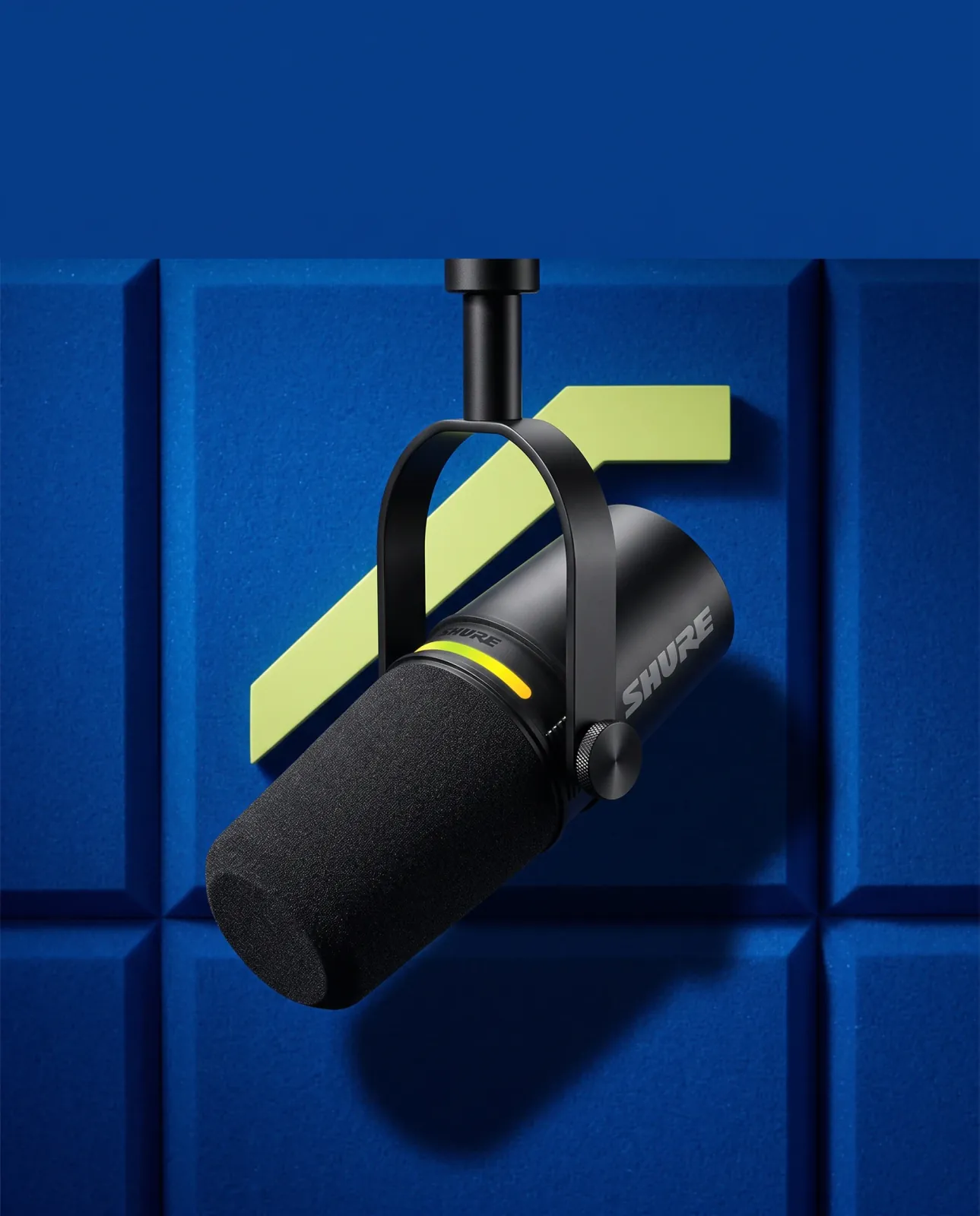 The same black Shure MV7+ microphone in a cobalt-blue campaign composition with a lime graphic accent.