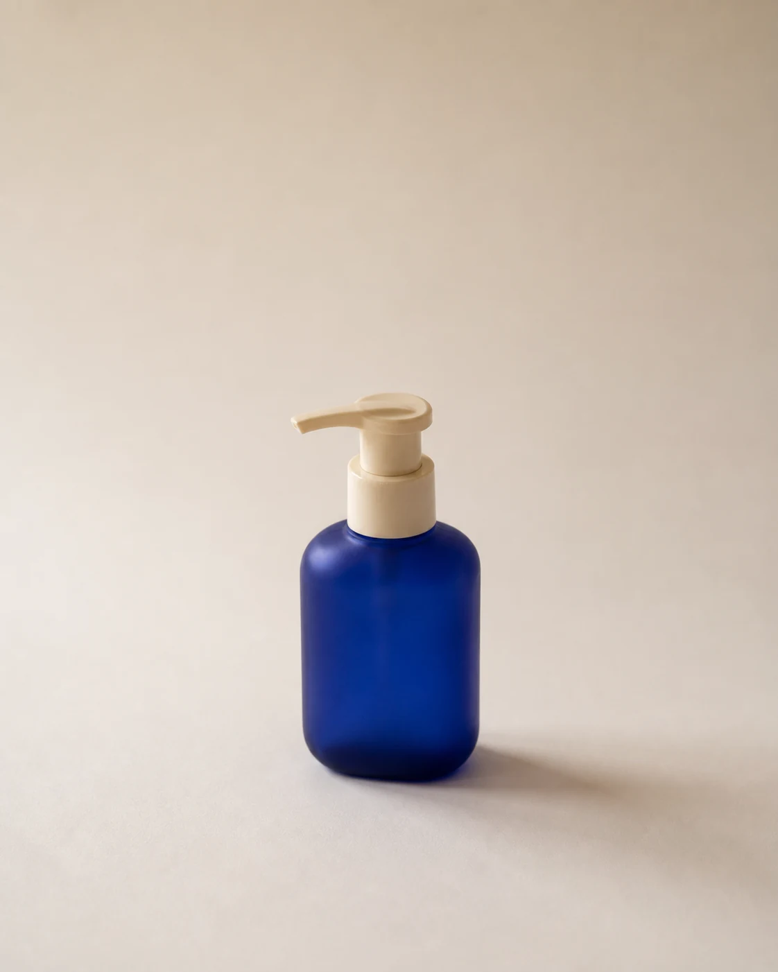 Blue pump bottle product photo before exposure and color correction.