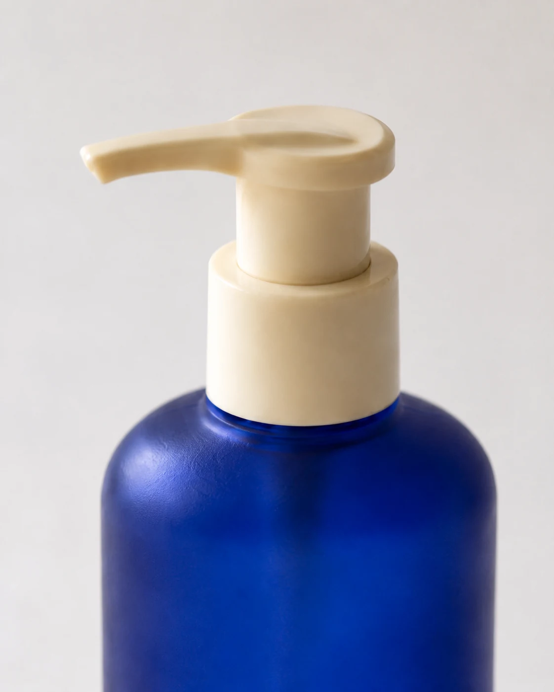 Close detail view of the blue pump bottle dispenser.