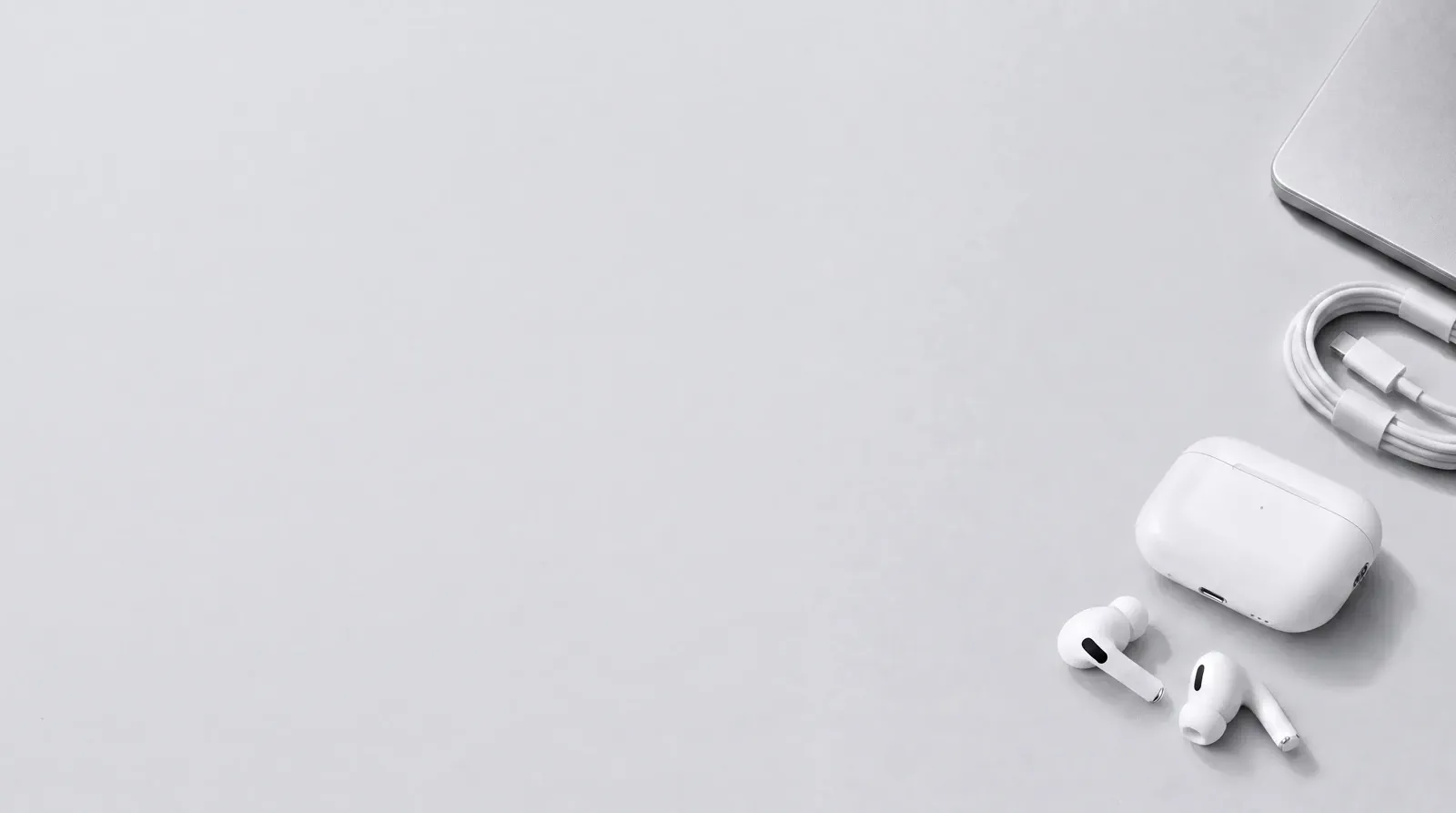 A compact top-down electronics layout with the product clustered on the right and clean copy space on the left.